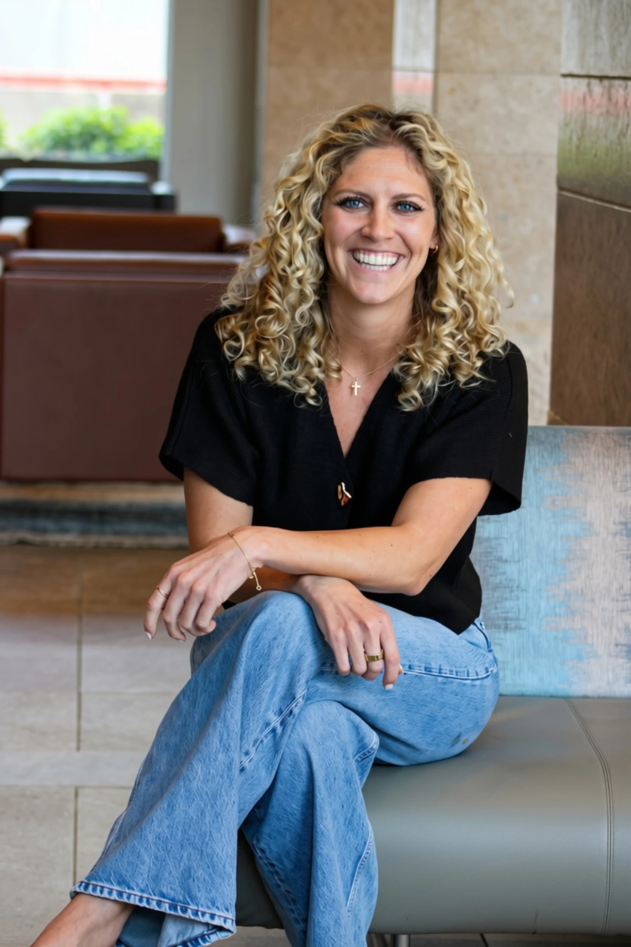 Peyton, founder of plantEd, smiling in a bright lobby